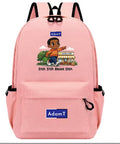 A pink backpack with black straps and trim, featuring a cartoon graphic of a boy stepping forward with the text 'STEP, STEP, BRAVE STEP.' and a blue 'AdamT' logo patch on the front pocket.